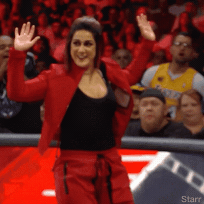 Woman In Red Jacket And Red Pants In Front Of Starr Logo GIF