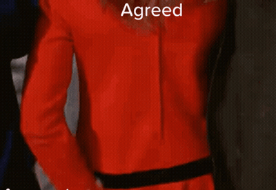 Woman In Red Jacket And White Gloves GIF