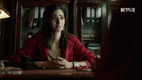 Woman In Red Jacket At Desk GIF