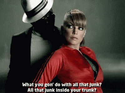 Woman In Red Jacket Beside Man In Black Suit And Hat GIF