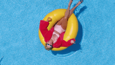 Woman In Red Jacket Floating On Yellow Raft GIF