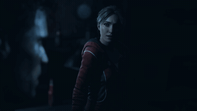 Woman In Red Jacket In Dark Room GIF
