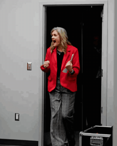 Woman In Red Jacket In Doorway Mouth Open GIF