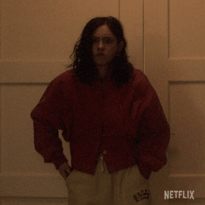 Woman In Red Jacket In Front Of Netflix Door GIF