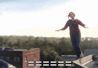 Woman In Red Jacket Jumping Off Ledge With CC GIF