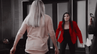 Woman In Red Jacket Next To Woman In Pink Shirt GIF