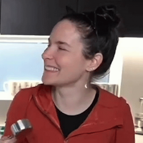 Woman In Red Jacket Smiling Holding Dumbbell GIF