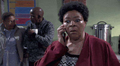 Woman In Red Jacket Talking On Phone GIF