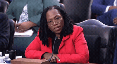 Woman In Red Jacket With Microphone GIF