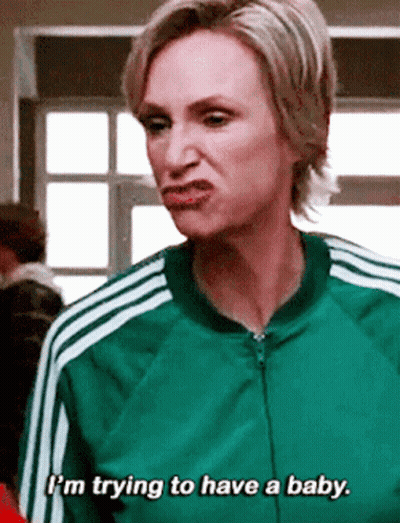 Woman In Red Jacket With Yellow Stripes Next To Man In Suit GIF