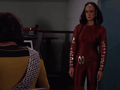 Woman In Red Jumpsuit And Man Saying You Are Late GIF