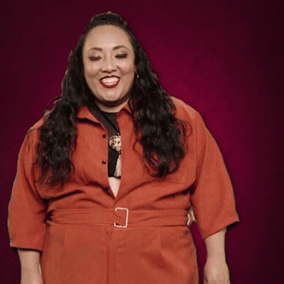 Woman In Red Jumpsuit With Buckle Belt GIF