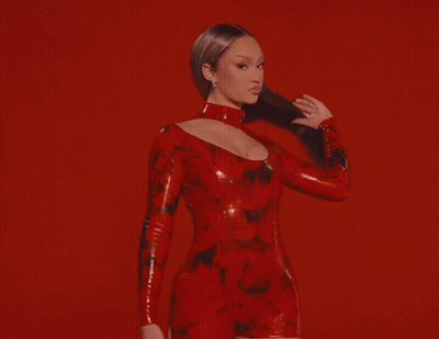 Woman In Red Latex Dress On Red Background GIF