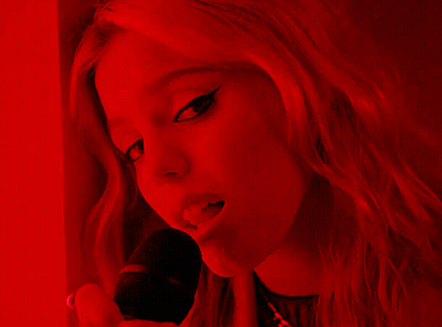 Woman In Red Light Holding Microphone GIF