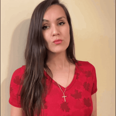 Woman In Red Maple Leaves Shirt Gold Cross GIF
