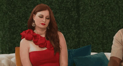 Woman In Red One-Shoulder Dress On Couch GIF