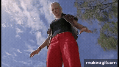 Woman In Red Pants And Black Shirt Under Blue Sky GIF