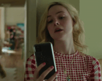 Woman In Red Plaid Shirt Looking At Cell Phone GIF