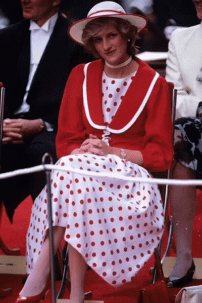 Woman In Red Polka Dot Dress Sitting GIF