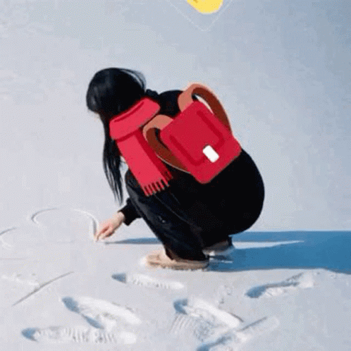 Woman in Red Scarf and Backpack Kneeling in Snow