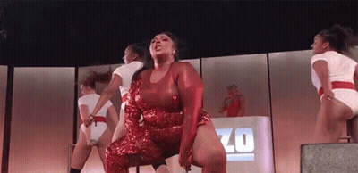 Woman In Red Sequined Dress Dancing Zo Sign GIF