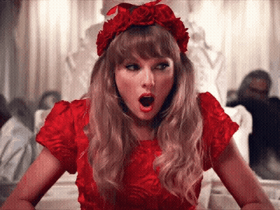 Woman In Red Sequined Jacket And Hat Winking GIF
