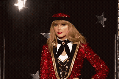 Woman In Red Sequined Jacket And Hat Winking GIF