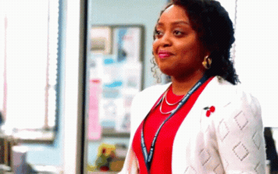Woman In Red Shirt And White Jacket Standing GIF