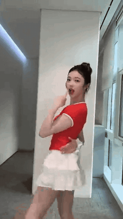 Woman In Red Shirt And White Skirt Dancing GIF