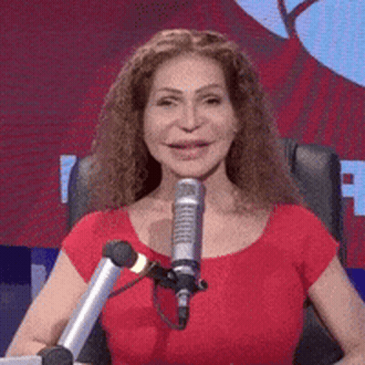 Woman In Red Shirt At Microphone Smiling GIF