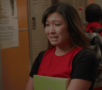 Woman In Red Shirt Crying And Covering Eyes GIF