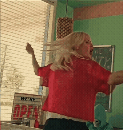 Woman In Red Shirt Dancing In Diner Window GIF