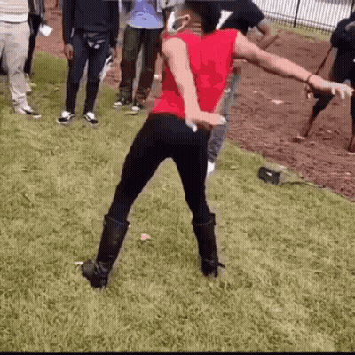 Woman In Red Shirt Dancing In Grass GIF