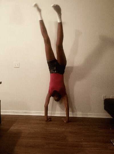 Woman In Red Shirt Doing Handstand GIF