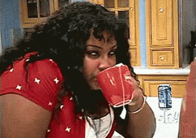 Woman In Red Shirt Drinking From Cup GIF