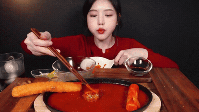Woman In Red Shirt Eating With Chopsticks And Spoon GIF