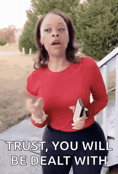 Woman In Red Shirt Holding Bible Pointing Saying Trust You Will Be Dealt With GIF