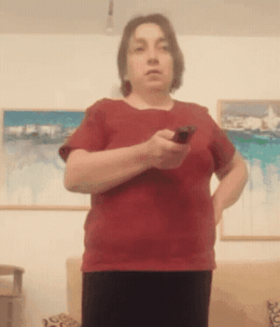Woman In Red Shirt Holding Remote Control GIF