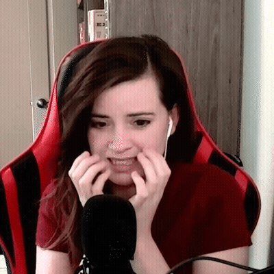 Woman In Red Shirt Making Funny Face At Microphone GIF