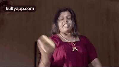 Woman In Red Shirt Making Funny Face Holding Bottle GIF