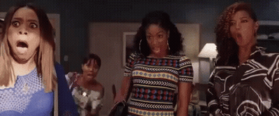 Woman In Red Shirt Making Funny Face In Crowd GIF