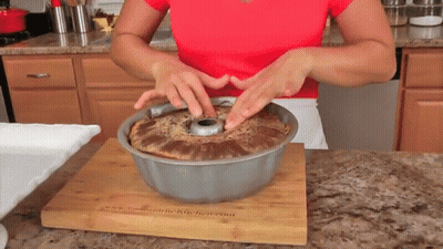 Woman In Red Shirt Putting Cake In Pan GIF