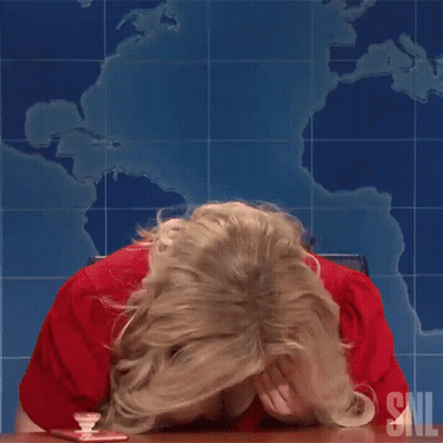 Woman In Red Shirt Sitting At Table With SNL Logo GIF