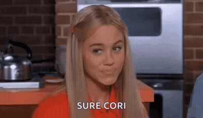 Woman In Red Shirt Sitting In Kitchen GIF