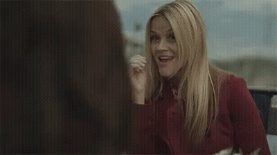 Woman In Red Shirt Smiling And Talking In Car GIF