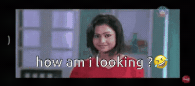 Woman In Red Shirt Smiling Asking How Am I Looking GIF