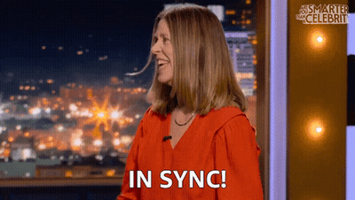 Woman In Red Shirt Smiling In Sync GIF