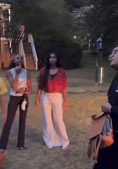 Woman In Red Shirt Standing Next To Another Woman GIF