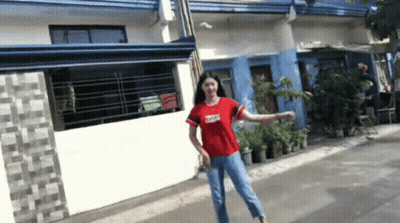 Woman In Red Shirt Standing On Street GIF