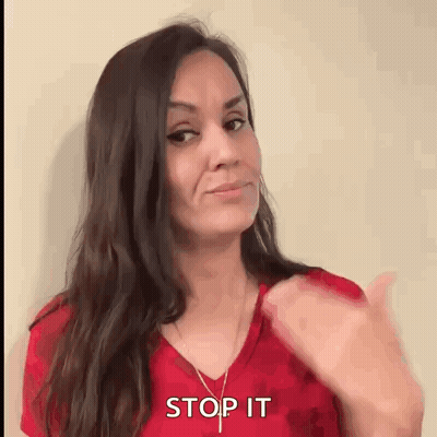 Woman In Red Shirt Thumbs Up Saying Stop It GIF